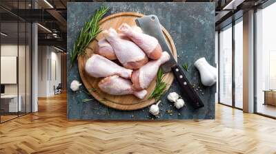 Raw uncooked chicken legs, drumsticks on wooden board, meat with ingredients for cooking, top view Wall mural