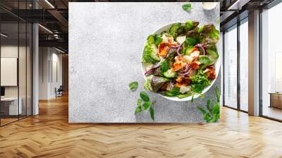 Salad with grilled salmon, fresh green salad leaves, cucumber, red onion, mint and pineapple. Healthy lunch salad for keto diet. Top view Wall mural