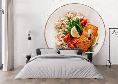 Salmon fish fillet baked, rice, green beans and tomatoes in lunch bowl. Healthy food, top view Wall mural