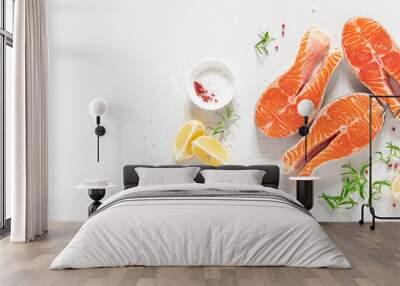 Salmon. Fresh raw salmon fish steaks with cooking ingredients, herbs and lemon on white background, top view, banner Wall mural