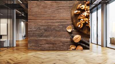 Walnuts. Kernels and whole nuts on wooden rustic table, banner, top view Wall mural