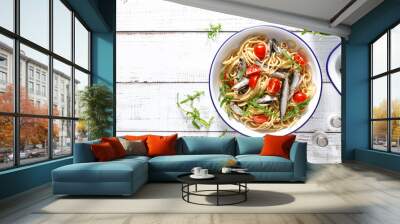 Whole grain pasta with sardines, tomato and arugula. Italian Sicilian cuisine, top view. Wall mural