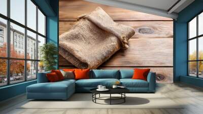 folded burlap hessian sack on wooden table Wall mural