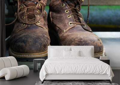 A pair of well used  leather work boots. Wall mural