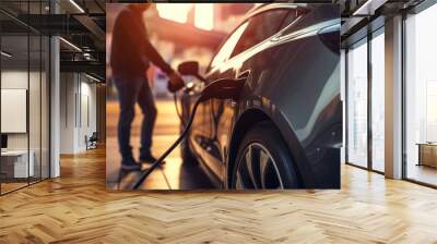 A person charging an electric car at a charging station, illustrating the shift toward electric transportation. Generative Ai. Wall mural