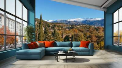 Beautiful autumn landscape of Sierra Nevada with snow capped mountains seen from the Alhambra, Granada, Andalusia, Spain Wall mural