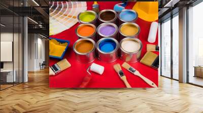 Collection of colored paints cans, Brush, red background Wall mural