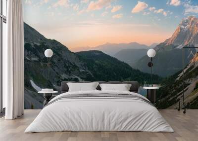 Beautiful scenery of rocky mountainous landscape at sunset surrounding a small lake Wall mural