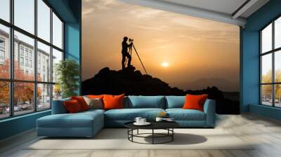 Silhouette of male landscape photographer shooting with a tripod Wall mural