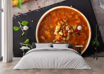 Eastern Europe traditional soup or borsch made with beef meat and vegetables on a dark slate Wall mural