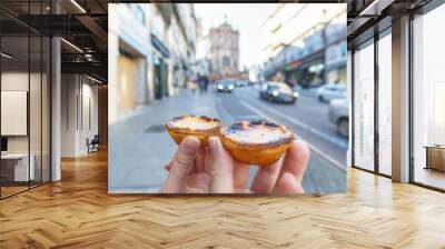 Tow Hand with Portugal's traditional sweet dessert Pastel de nata egg custard tart pastry with street in Porto, Portugal Wall mural