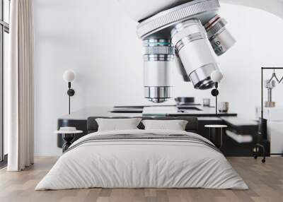 Using a biological microscope. Close-up of the microscope lens. Scientific research concept, using a microscope. Medical examinations, searching for bacteria, diseases, blood tests. Wall mural