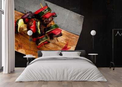 Tasty vegetable skewer on a wooden board with sliced papers aside. Black wooden board with space for text. Wall mural