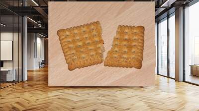 a biscuit broken into two pieces on a wooden board Wall mural