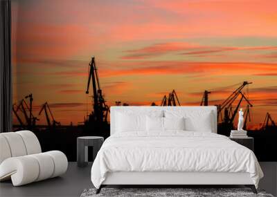 landscape with the silhouettes of cranes from the port of Constanta in the evening Wall mural