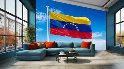 Venezuela flag waving in the wind against a blue sky background Wall mural