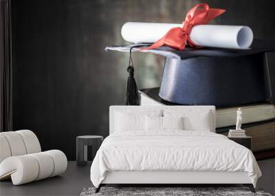 Graduation hat and diploma on table Wall mural