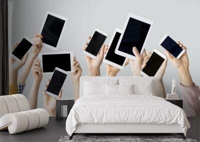 hands raising technological devices Wall mural