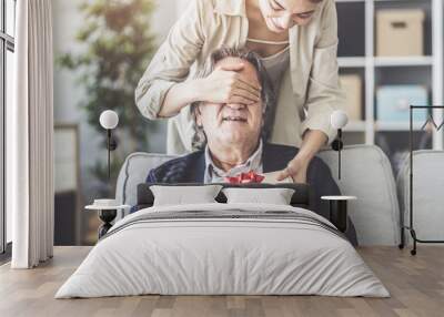 Young daughter gives her father a gift Wall mural