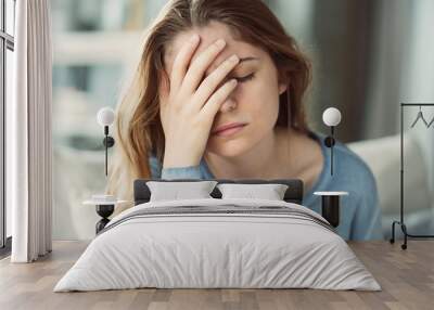 Young woman with headache Wall mural