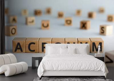 acronym - word from wooden blocks with letters, use of acronyms in the modern world abbreviation concept, random letters around, top view on wooden background Wall mural