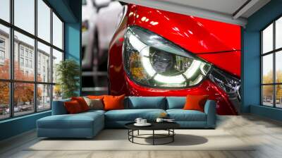 Headlights and hood of sport red car with silver stars Wall mural