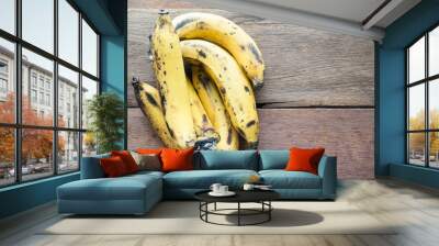 ripe bananas over on wood table  with top view Wall mural