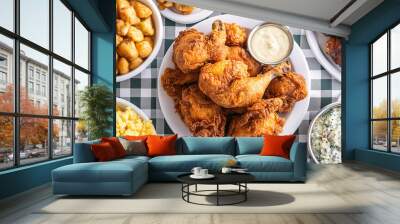 A southern-style dinner table covered in checkered cloth, with a centerpiece of fried chicken and classic sides Wall mural