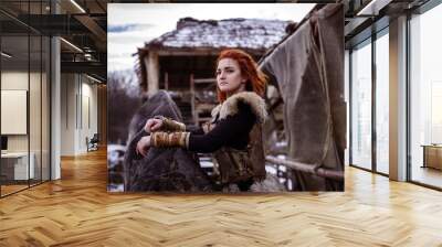 Viking woman with hammer in a traditional warrior clothes. Wall mural