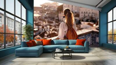 Female tourist looking at old town from balcony Wall mural