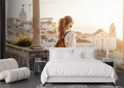 Person looking at breathtaking view of the city in Europe during the sunset Wall mural