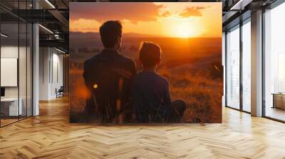 A father and son watching the sunset together, sharing a moment of tranquility and bonding amidst the beauty of nature. Wall mural