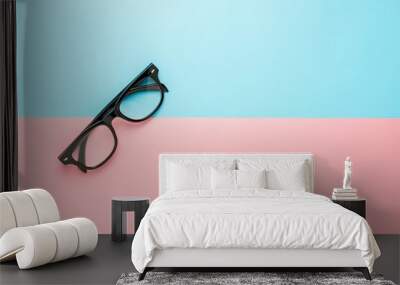 black glasses on blue and pink background. Wall mural