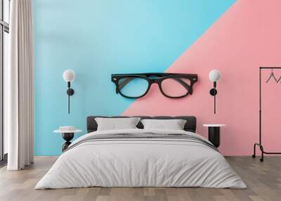 black glasses on blue and pink background. Wall mural