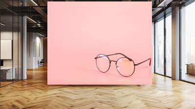 Eyeglasses on pink background. Wall mural