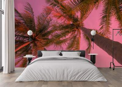 Pink exotic background with palm trees under the sun. Adorable vacation travel design. Pink sunset landscape Wall mural