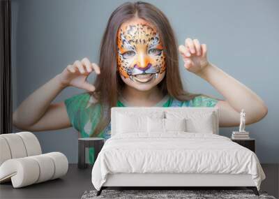 beautiful girl with a tiger painted on his face on a gray background Wall mural