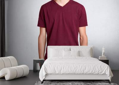 Studio shot of casual dark red t shirt, presented over white background. Cotton item of clothes worn on slender tall young man being in role of model. People, clothes and advertising company. Wall mural