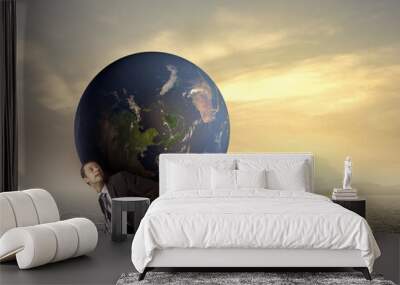 Businessman golding earth on his back Wall mural