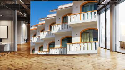 Balconies and blue sky. Part of a residential building in Mexico. Modern apartment buildings on a sunny day. Architectural details. The facade of the hotel is in the colonial style. Wall mural