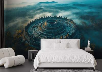 Aerial view of ancient circular structure surrounded by misty landscape Wall mural