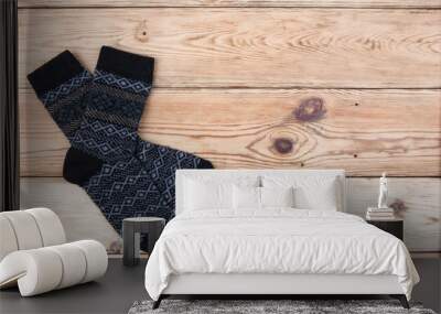 Knitted wool socks on wooden background - copy space for text Wall mural