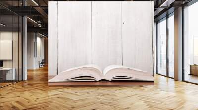 Open book on the desk over wooden background Wall mural