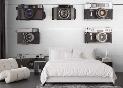 Set of vintage film cameras on wooden table Wall mural