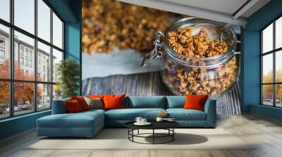 Open glass jar with homemade granola 
 Wall mural