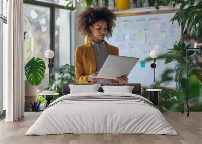 businesswoman surrounded by papers and a laptop preparing for a presentation Wall mural