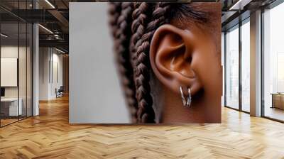 Close up of Woman s Ear with Braided Hair and Silver Hoop Earrings Wall mural