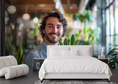 smiling millennial male employee in coworking office Wall mural