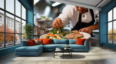 A close-up of a chef’s hand adding salad garnish to a plate with grilled salmon steak. Wall mural