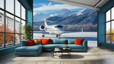 A white luxury jet, corporate plane, parked on the runway with a beautiful snow-covered mountain backdrop. Wall mural